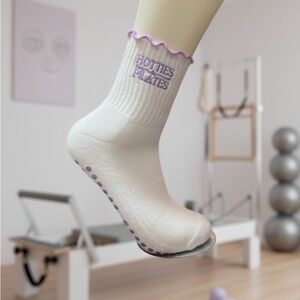 The Carriage Club “Hotties do Pilates” Purple ruffle grip socks